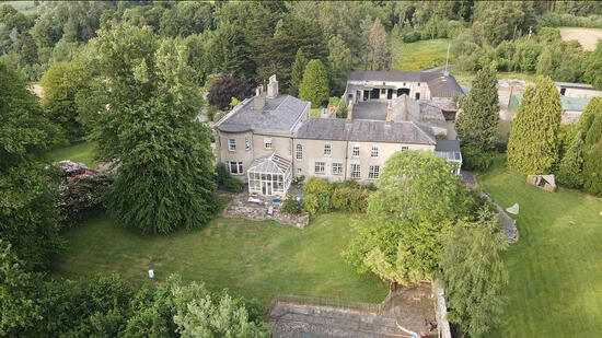 Woodbank from the air, among mature trees and lawns