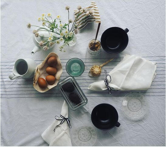 Breakfast laid out with eggs, coffee and flowers